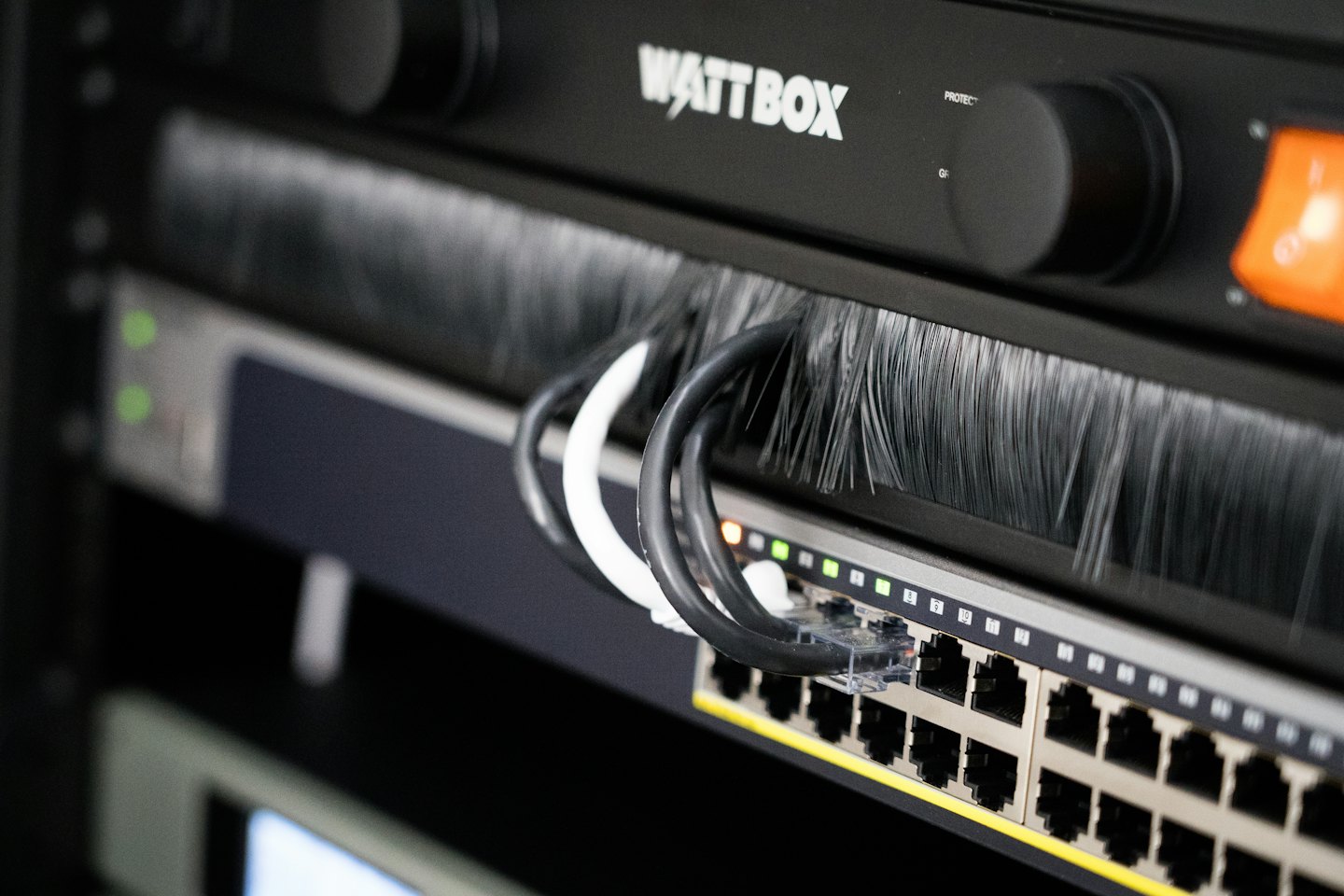 Server rack with network cables and Wattbox power unit.